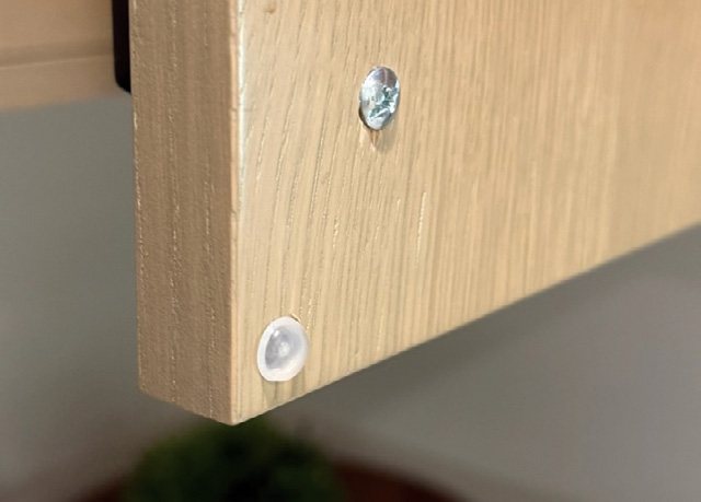 Bumper installed in the corner of a cabinet door